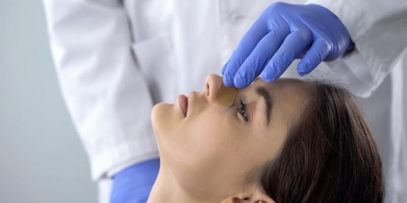 woman receiving rhinoplasty nose job treatment