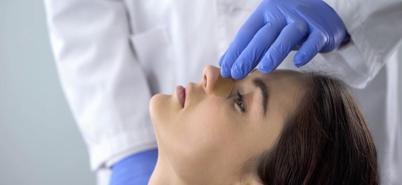 woman receiving rhinoplasty nose job treatment