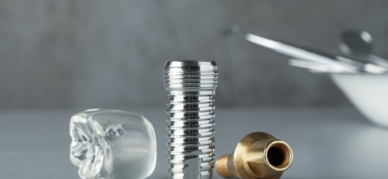 Parts,Of,Dental,Implant,On,Grey,Table,,Closeup