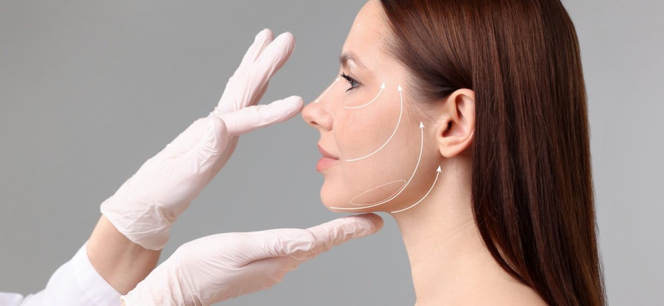 Woman,Preparing,For,Plastic,Surgery,,Grey,Background.,Doctor,Examining,Her