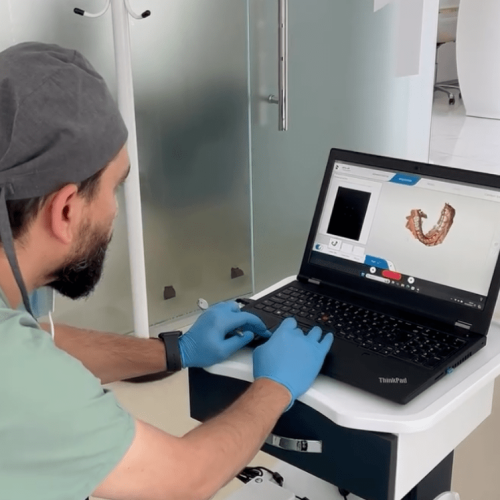 Dentist Bilal Turan is treating a patient at his private clinic Sindent Dental Clinic