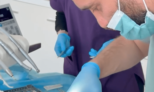 Dentist Bilal Turan is treating a patient at his private clinic Sindent Dental Clinic