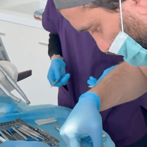 Dentist Bilal Turan is treating a patient at his private clinic Sindent Dental Clinic