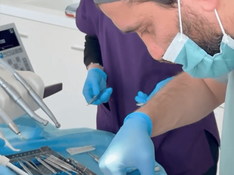 Dentist Bilal Turan is treating a patient at his private clinic Sindent Dental Clinic