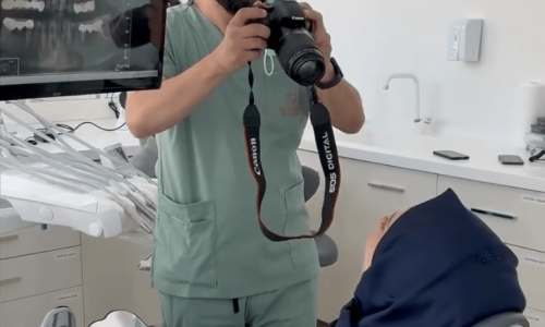 Dentist Bilal Turan is treating a patient at his private clinic Sindent Dental Clinic