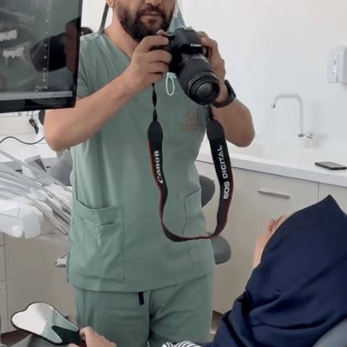 Dentist Bilal Turan is treating a patient at his private clinic Sindent Dental Clinic