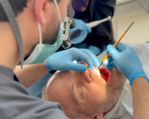 Dentist Bilal Turan is treating a patient at his private clinic Sindent Dental Clinic