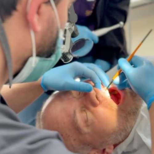 Dentist Bilal Turan is treating a patient at his private clinic Sindent Dental Clinic
