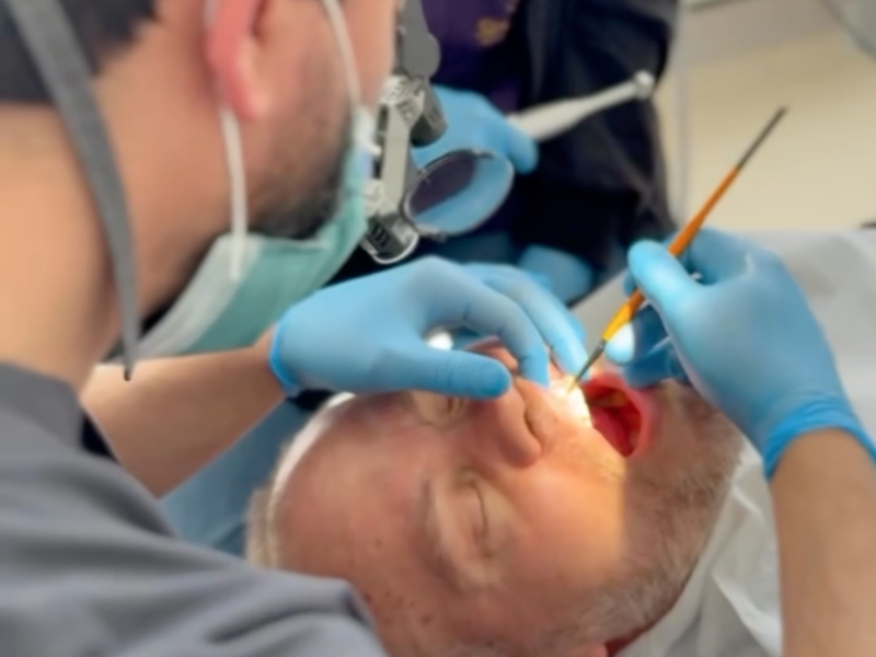 Dentist Bilal Turan is treating a patient at his private clinic Sindent Dental Clinic