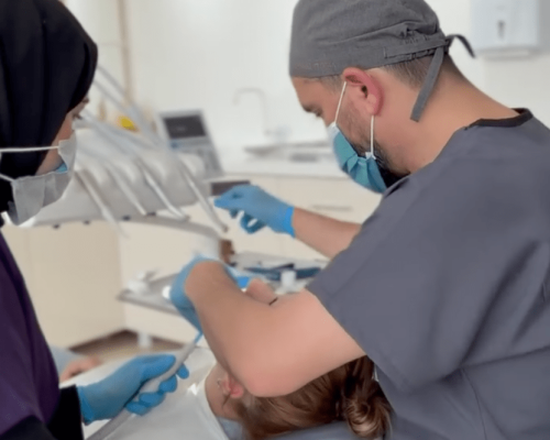 Dentist Bilal Turan is treating a patient at his private clinic Sindent Dental Clinic