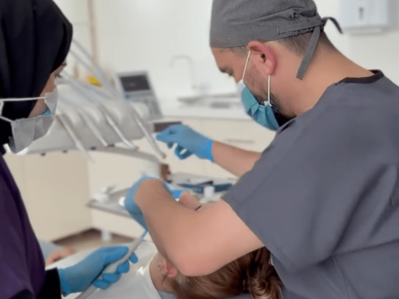 Dentist Bilal Turan is treating a patient at his private clinic Sindent Dental Clinic